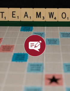 Scrabble letter blocks lined up to form the word "Team".